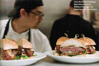 Chef de Cuisine Esteban Martinez prepares Avenue N burger for opening night customers.